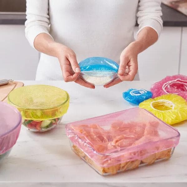 Easylife product image - Person applying colorful, reusable elasticated food covers to glass bowls and containers.